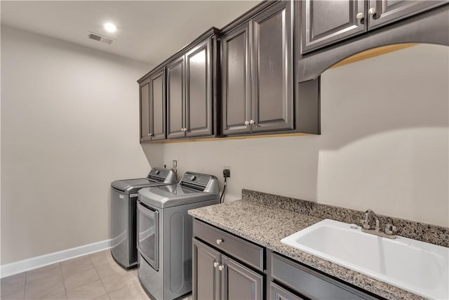 1765 Stevensan Dr, Franklin Park, PA 15143 - laundry area with cabinet space, washer and clothes dryer, baseboards, light tile patterned floors, and arched walkways