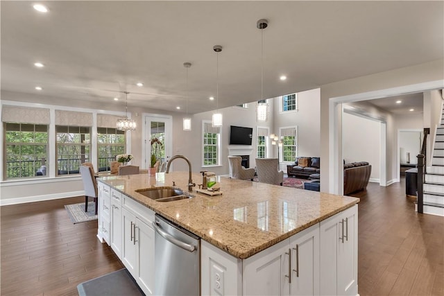 1765 Stevensan Dr, Franklin Park, PA 15143 - kitchen featuring stainless steel dishwasher, a sink, open floor plan, dark wood-style floors, and white cabinets