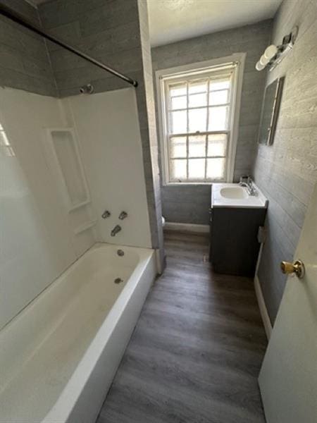 816 Franklin Ave, Aliquippa, PA 15001 - bathroom with tub / shower combination, vanity, wood finished floors, and baseboards