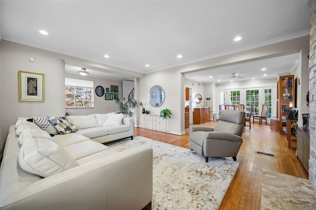 living room with crown molding, recessed lighting, a ceiling fan, and wood finished floors