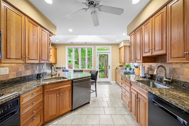kitchen featuring black appliances, a sink, brown cabinetry, and recessed lighting