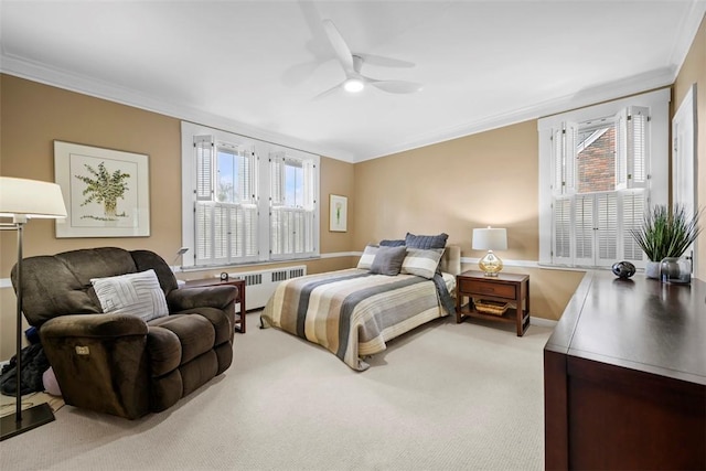 carpeted bedroom with crown molding, radiator, multiple windows, a ceiling fan, and baseboards