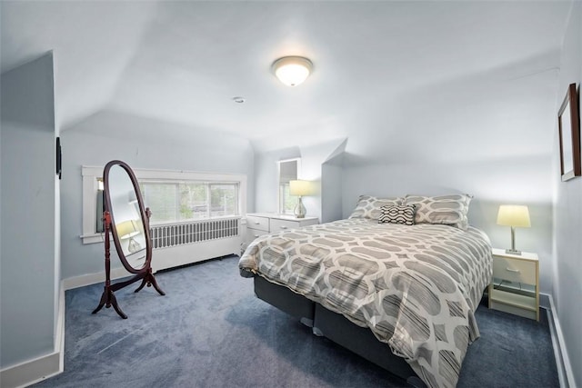 carpeted bedroom featuring lofted ceiling and baseboards
