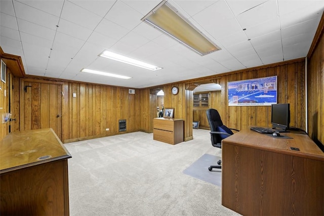 office with carpet floors and wood walls