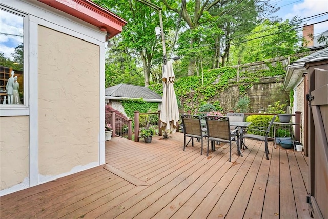 wooden deck featuring outdoor dining area