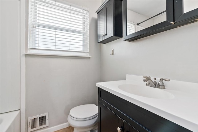 bathroom with toilet, vanity, a shower, and a bathtub