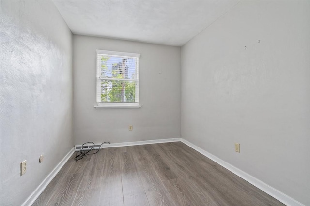 empty room with wood finished floors and baseboards