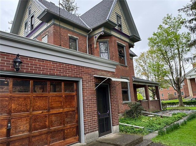 816 Main St, Brockway, PA 15824 - view of front of house with brick siding, a garage, and roof with shingles