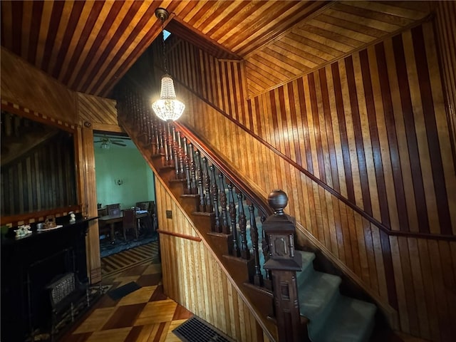 816 Main St, Brockway, PA 15824 - staircase with wood walls, a chandelier, and ceiling fan