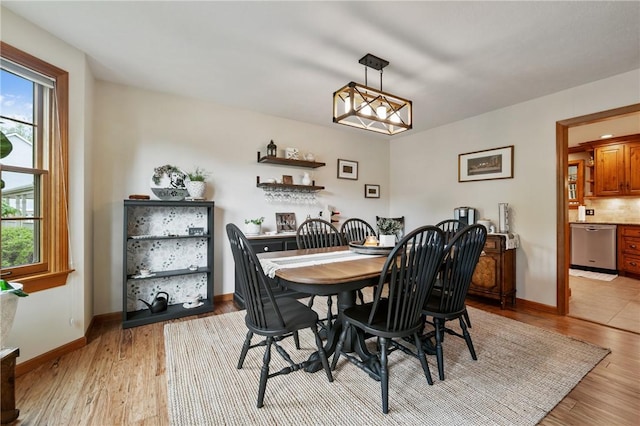 dining room featuring light wood-style floors and baseboards