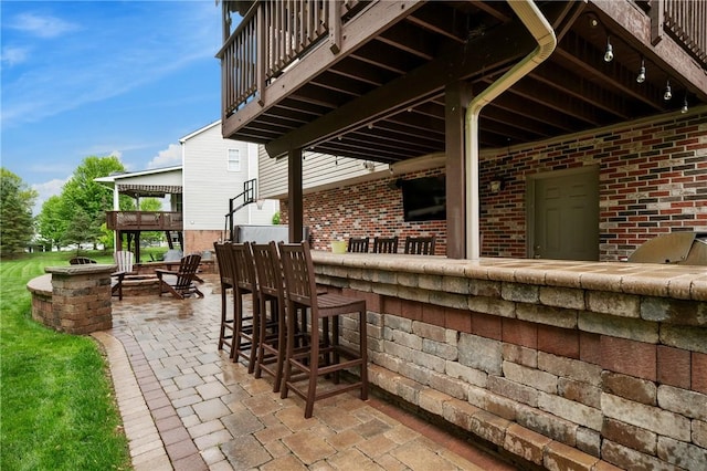 view of patio / terrace featuring a fire pit and a balcony
