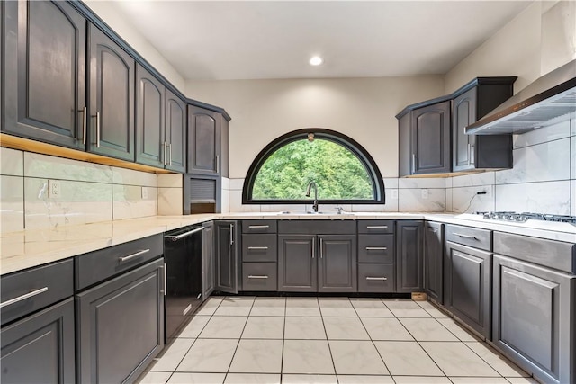 kitchen featuring a sink, wall chimney range hood, dishwasher, backsplash, and recessed lighting