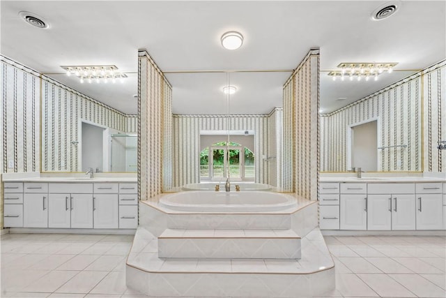 bathroom featuring wallpapered walls, tile patterned flooring, a shower stall, two vanities, and a garden tub