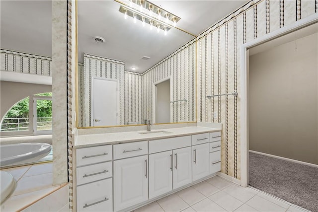 bathroom with vanity, tile patterned flooring, wallpapered walls, a garden tub, and baseboards