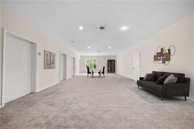 carpeted living room featuring recessed lighting and baseboards