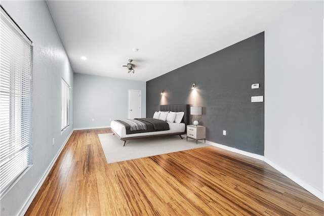 bedroom featuring wood finished floors and baseboards
