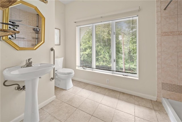full bath with a tile shower, toilet, baseboards, and tile patterned flooring