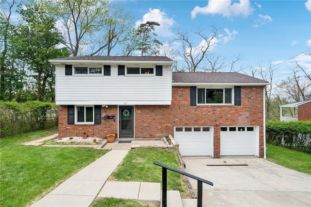 split level home featuring a garage, concrete driveway, a front yard, and brick siding