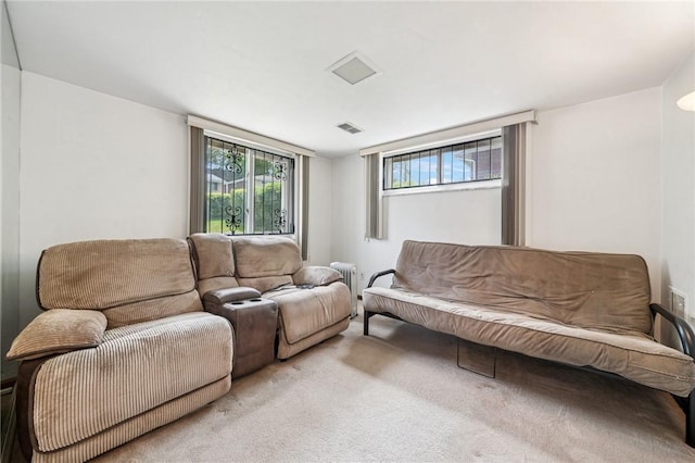 carpeted living room with radiator heating unit