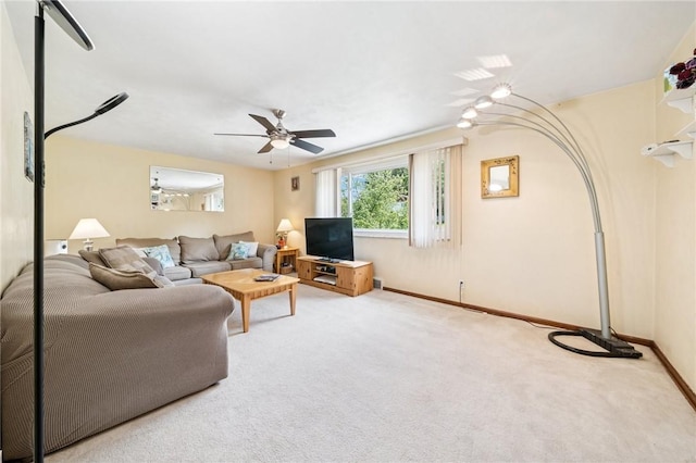living area with ceiling fan, carpet, and baseboards