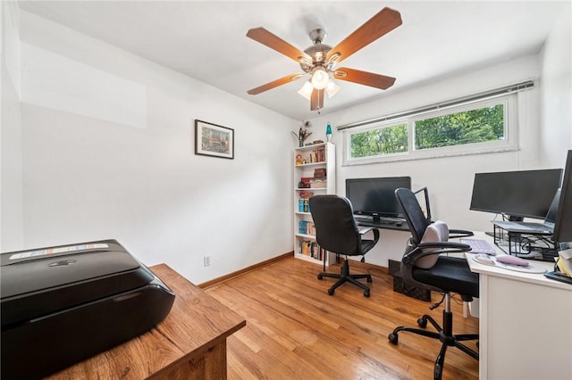 office area with light wood-style floors, baseboards, and ceiling fan