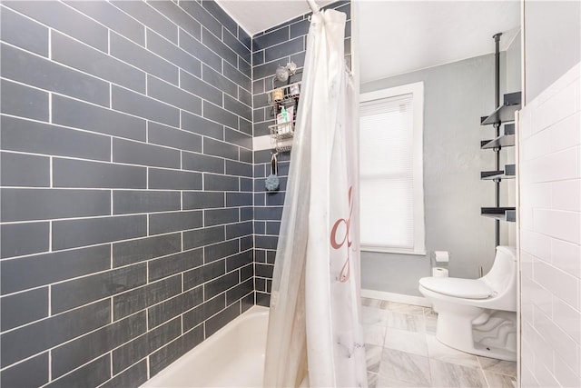 bathroom with toilet, marble look tiles, shower / bath combo, and baseboards