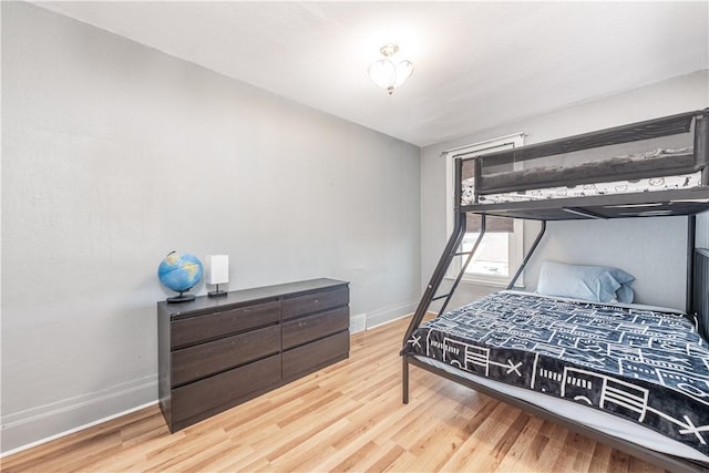 bedroom featuring wood finished floors and baseboards