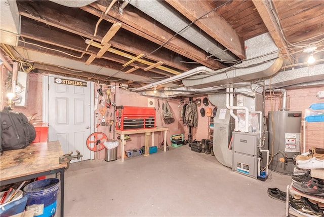 unfinished basement with gas water heater and a workshop area