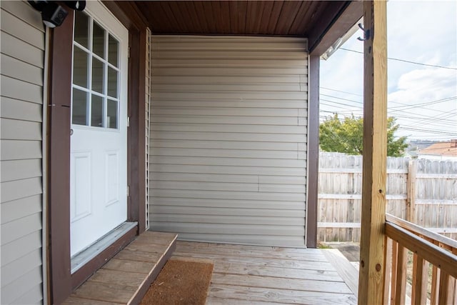 wooden terrace featuring fence