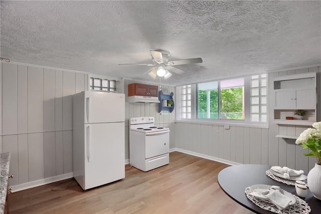 kitchen with white appliances, light wood-style flooring, a ceiling fan, a textured ceiling, and under cabinet range hood