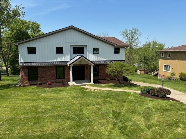 120 Candlelite Dr, Peters Twp, PA 15317 - view of front of house featuring a front lawn, board and batten siding, and brick siding