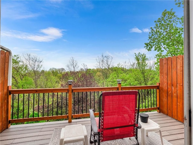 wooden deck featuring a forest view