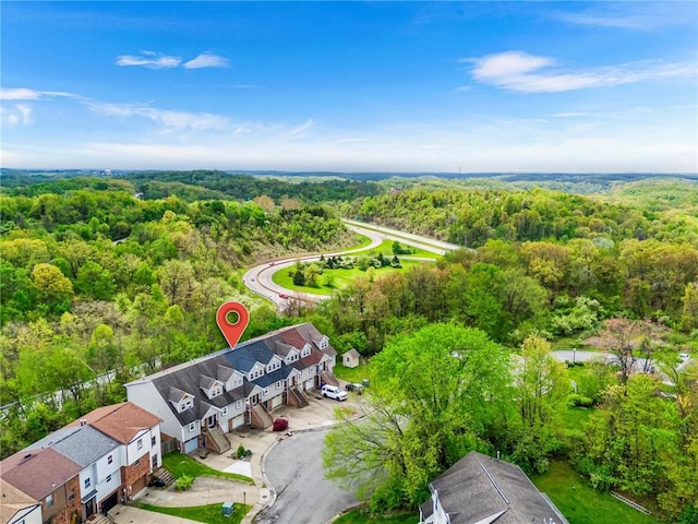 aerial view of residential area featuring a forest