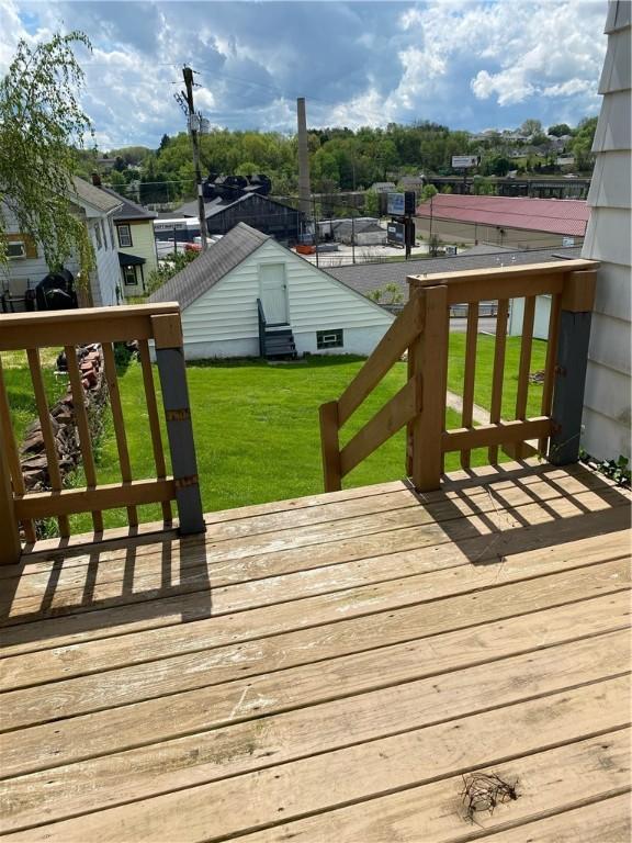 wooden terrace with a lawn