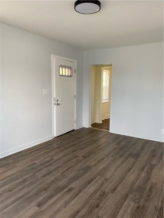 entrance foyer with dark wood-style floors and baseboards