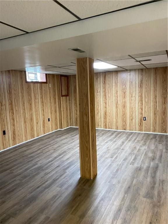 below grade area featuring wood walls and wood finished floors