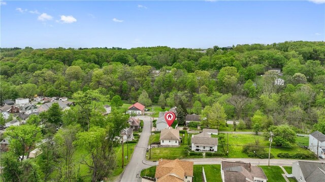 aerial perspective of suburban area with a heavily wooded area