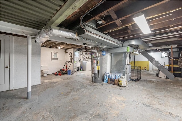 unfinished below grade area with water heater, washer / clothes dryer, and heating unit