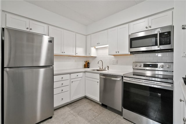 2120 Greentree Rd Unit 705E, Scott Twp Sal, PA 15220 - kitchen featuring stainless steel appliances, a sink, white cabinetry, decorative backsplash, and light countertops