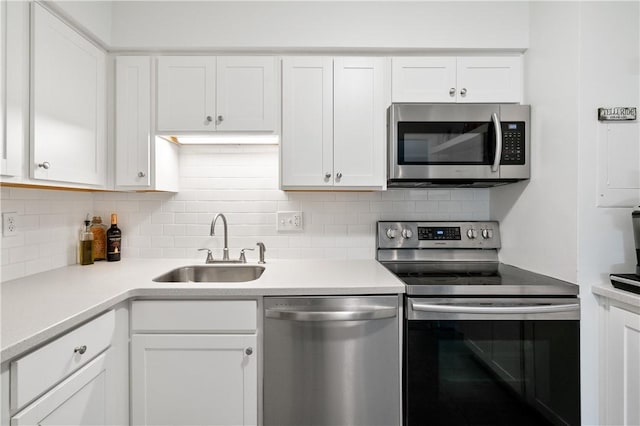 2120 Greentree Rd Unit 705E, Scott Twp Sal, PA 15220 - kitchen featuring appliances with stainless steel finishes, a sink, white cabinetry, and tasteful backsplash