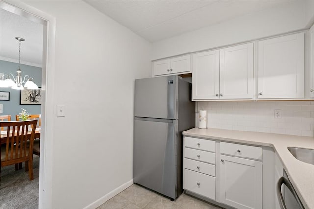 2120 Greentree Rd Unit 705E, Scott Twp Sal, PA 15220 - kitchen with appliances with stainless steel finishes, tasteful backsplash, white cabinets, light countertops, and a chandelier