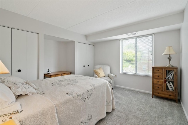 2120 Greentree Rd Unit 705E, Scott Twp Sal, PA 15220 - bedroom featuring two closets, baseboards, and carpet