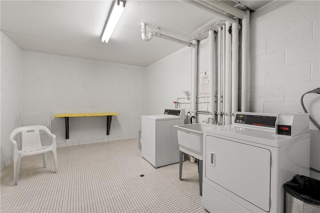2120 Greentree Rd Unit 705E, Scott Twp Sal, PA 15220 - washroom with separate washer and dryer, concrete block wall, and a sink