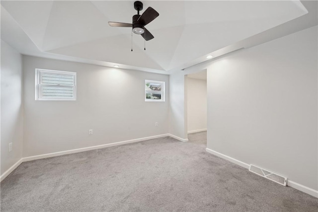 basement featuring carpet flooring, a ceiling fan, and baseboards