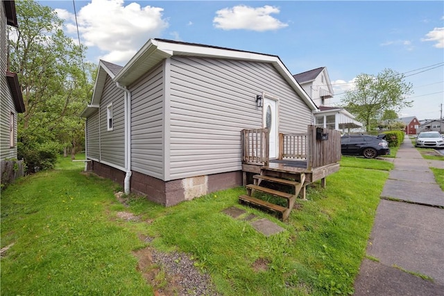 view of side of property featuring a yard and crawl space