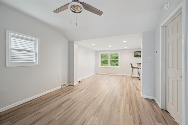 unfurnished living room featuring ceiling fan, light wood-style floors, vaulted ceiling, baseboards, and recessed lighting