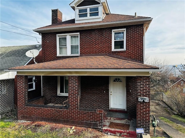american foursquare style home with brick siding