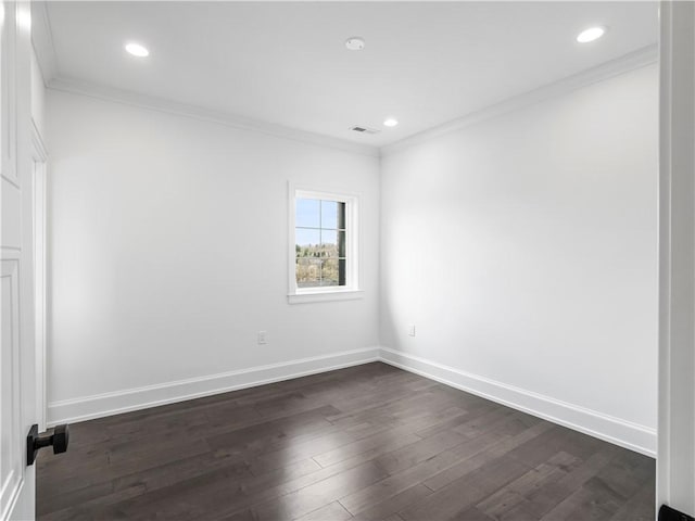 empty room featuring ornamental molding, dark wood-type flooring, baseboards, and recessed lighting