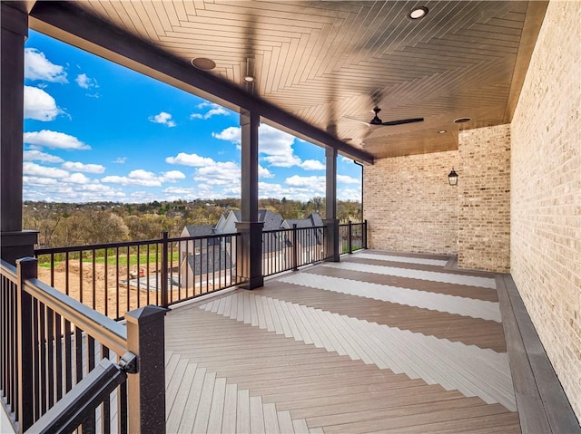 wooden terrace with a ceiling fan