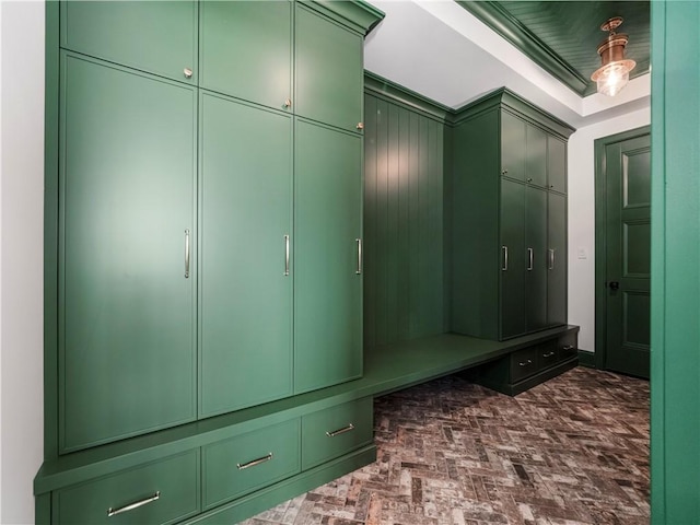 mudroom featuring brick patterned flooring and a raised ceiling
